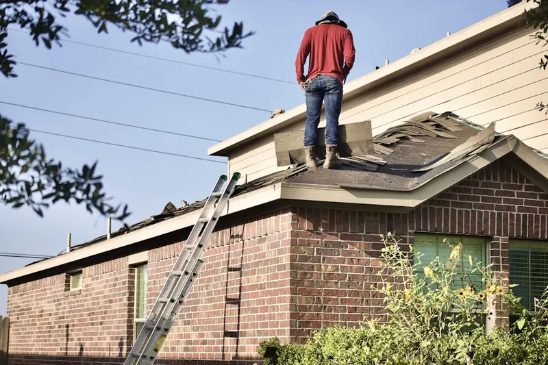 Professional roofer working on a residential roof in Mill Road